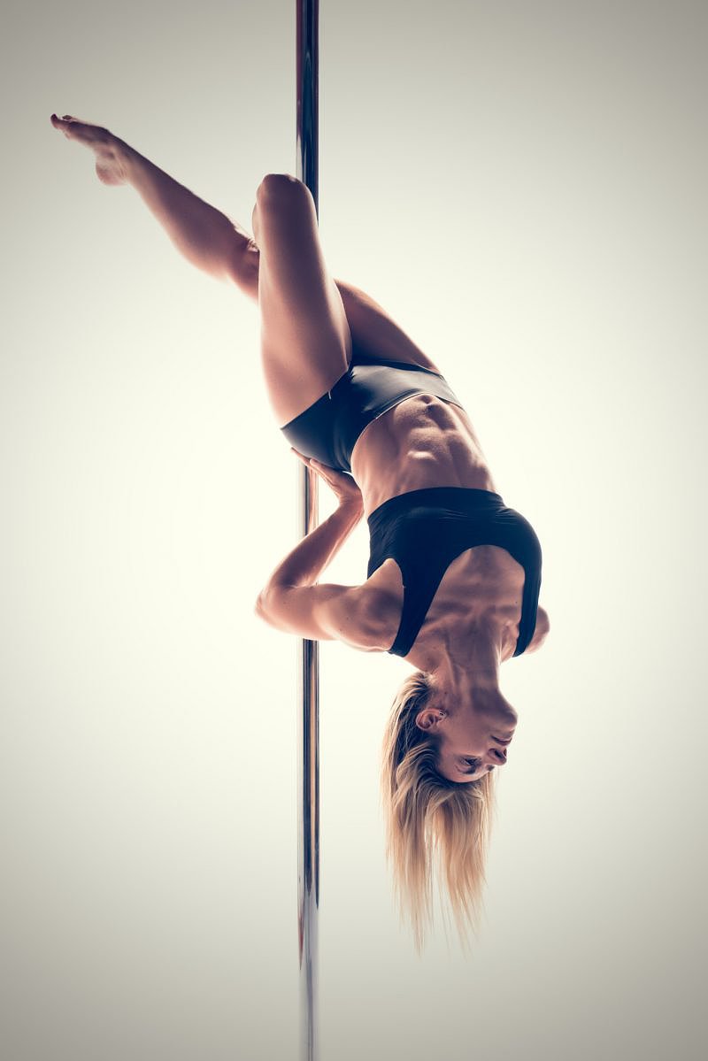 Pole fitness move called X knee release (Cross Knee Release)